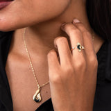 A woman wearing a Sealife Seahorse Black Coral Ring in Gold with Diamonds and a neckalce - Maui Divers Jewelry