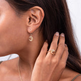 A womanʻs ear with Nalu Earrings in Gold with Diamonds - 28mm-Maui Divers Jewelry
