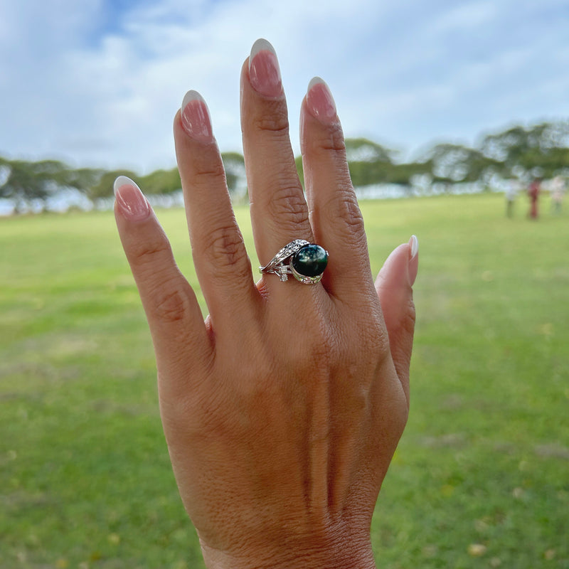 A woman's hand with a Tahitian Black Pearl Ring with Diamonds in 14K White Gold (9-10mm)-Maui Divers Jewelry