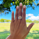 A woman's hand wearing a Plumeria Ring in Gold with Diamond - 8mm - Maui Divers Jewelry