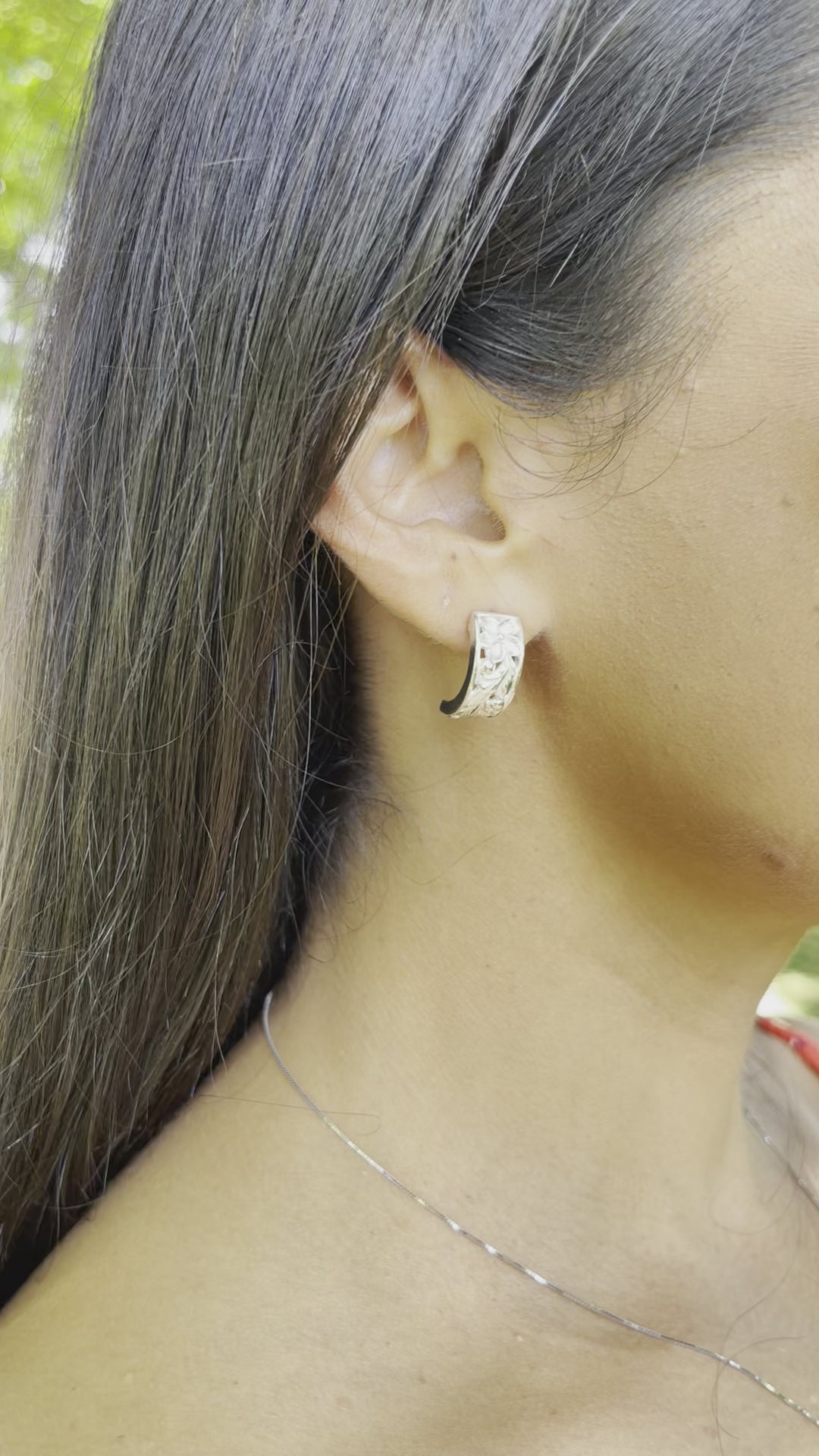 Video of a woman wearing Hawaiian Heirloom Plumeria Scroll Hoop Earrings in Sterling Silver - 8mm - Maui Divers Jewelry