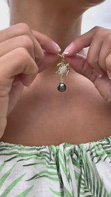 Video of a woman holding an Ocean Dance Honu (Sea Turtle) Tahitian Black Pearl Pendant in Gold with Diamonds - 9-10mm - Maui Divers Jewelry