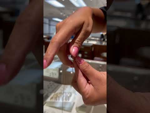 Video of a woman showing how to create ethe Puffy Plumeria Necklace Look - Maui Divers Jewelry