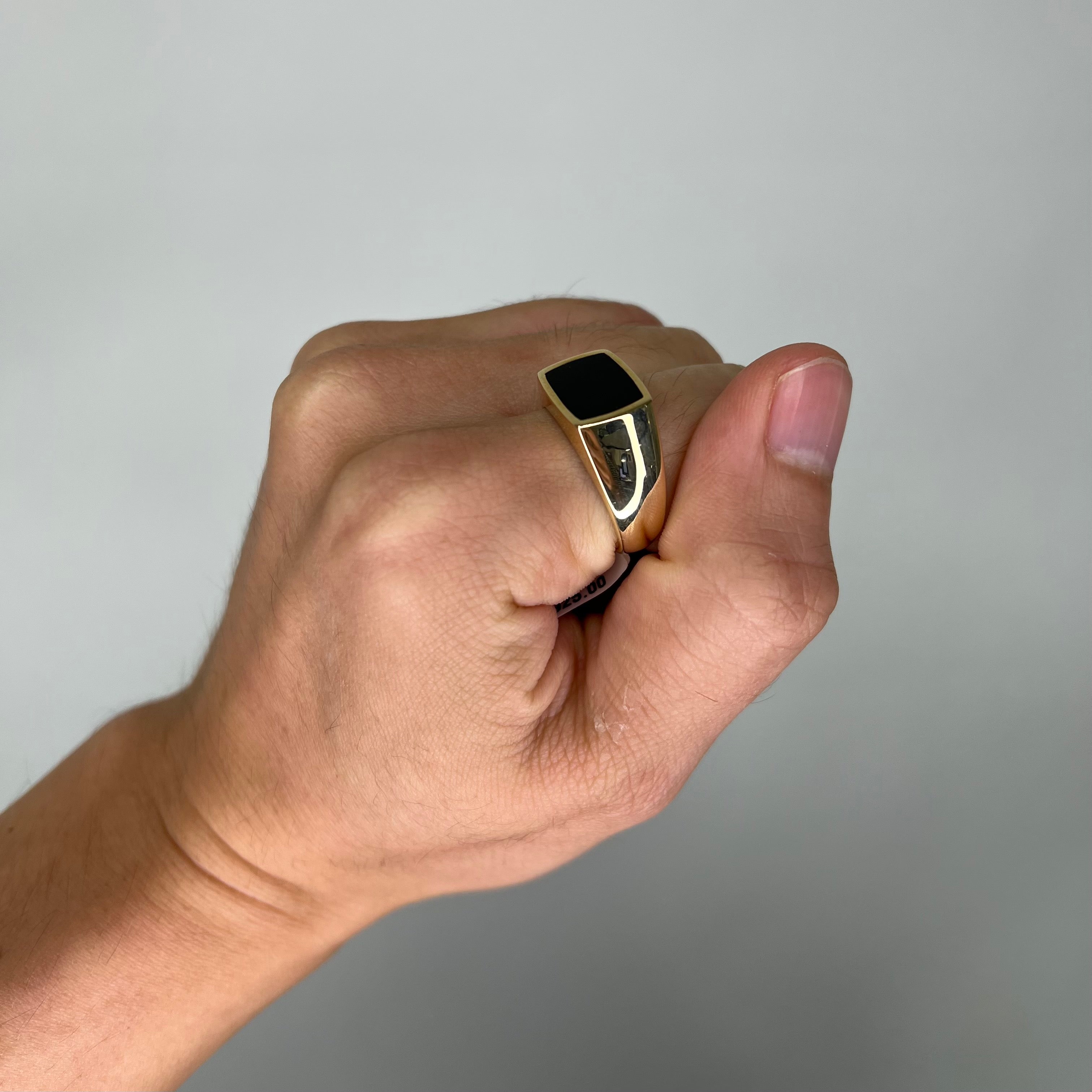 A man's hand with a Black Coral Ring in Gold - Maui Divers Jewelry