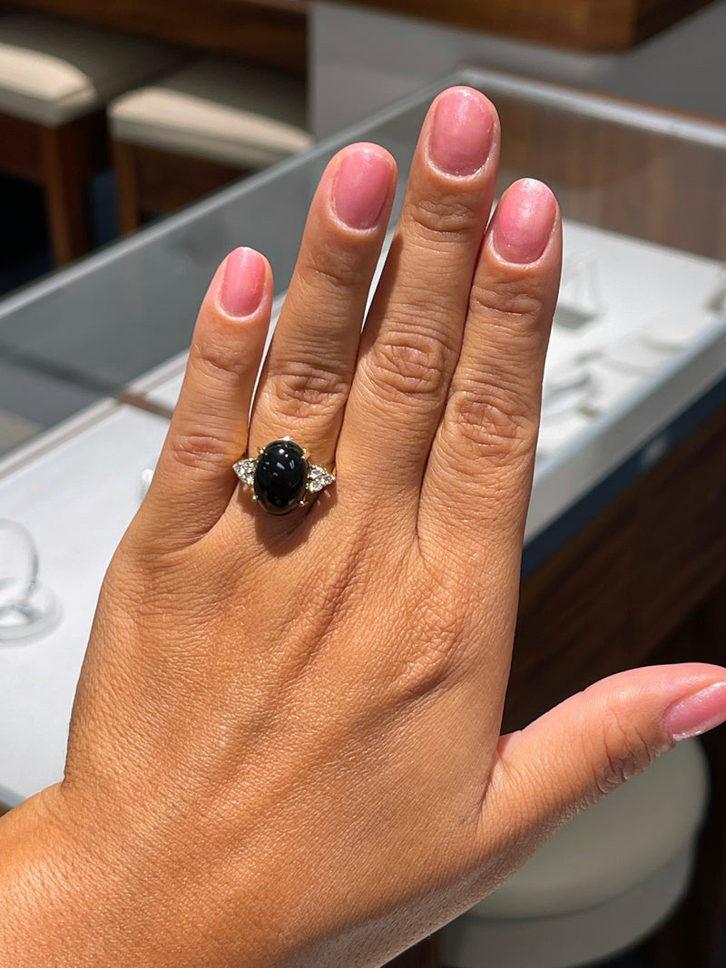 A woman's hand wearing a Black Coral Ring in Gold with Diamonds - Maui Divers Jewelry