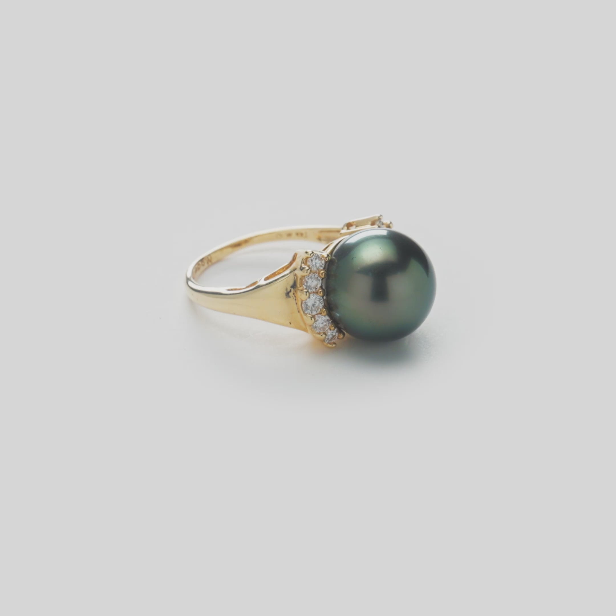 Video of the Tahitian black pearl ring in 14k yellow gold with diamonds on a white background