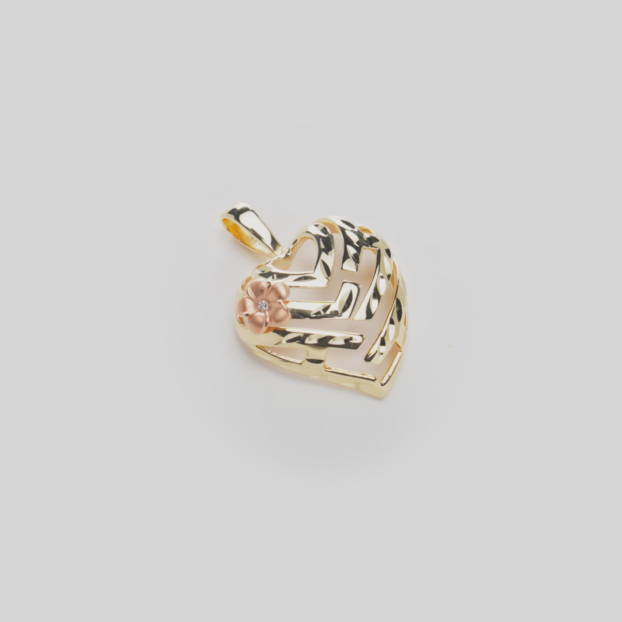 Video of the Aloha Heart Pendant in 14k Yellow Gold with a Diamond Accented Plumeria in 14k Rose Gold on a White Background